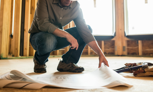 Worker looking at blueprints